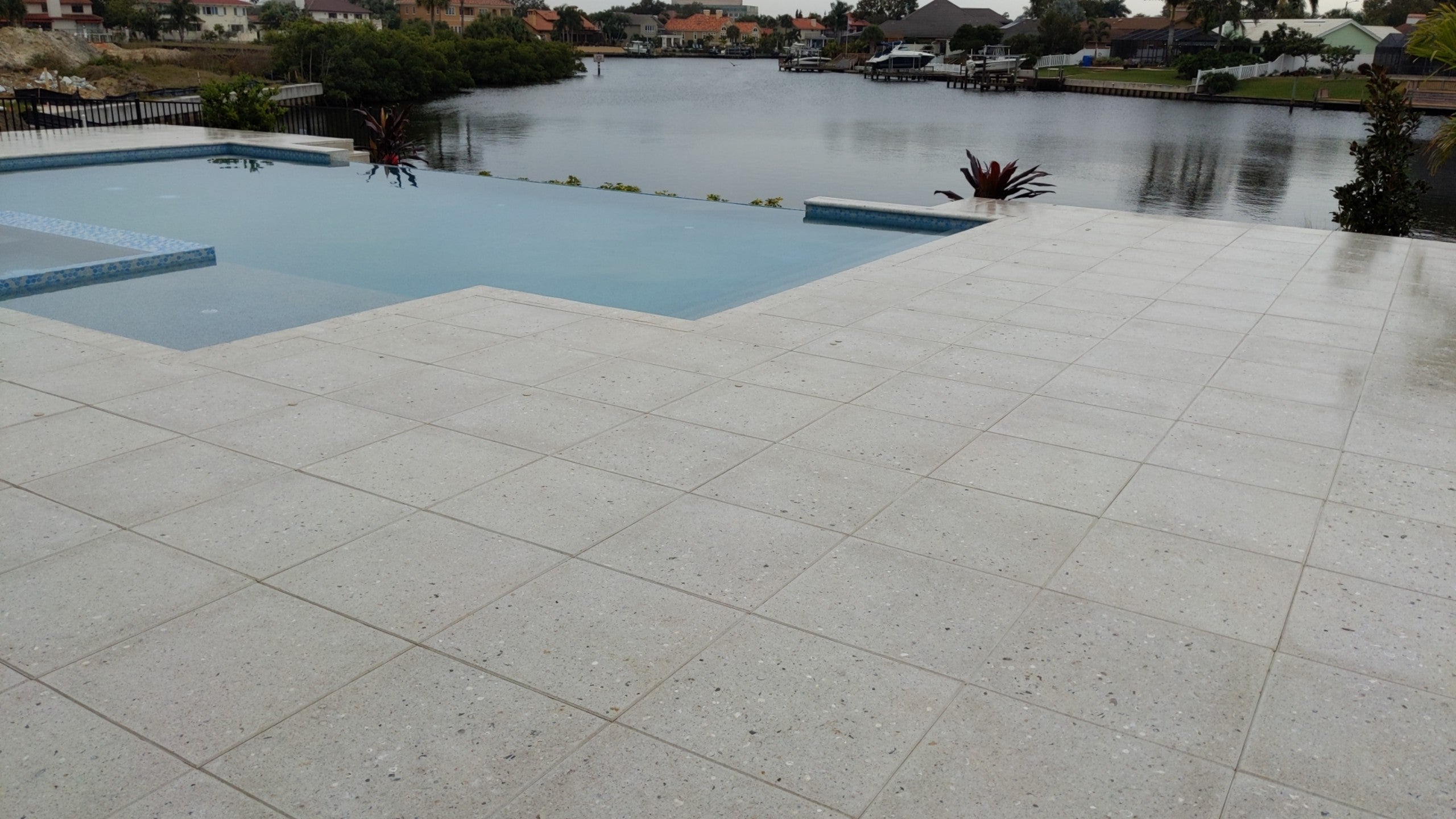 Paver pool deck looking out on a lake