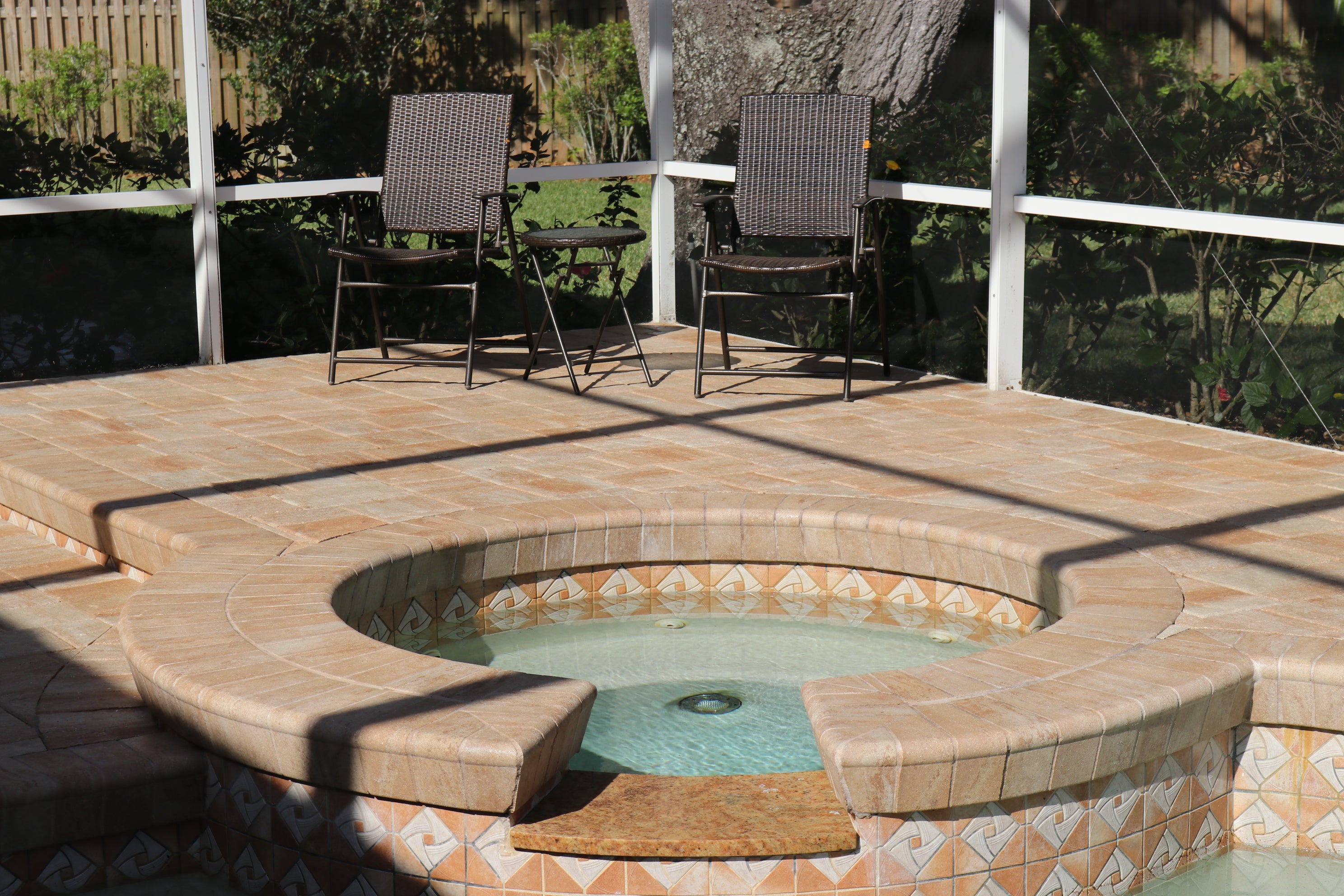 Chairs and hot tube on a pool deck