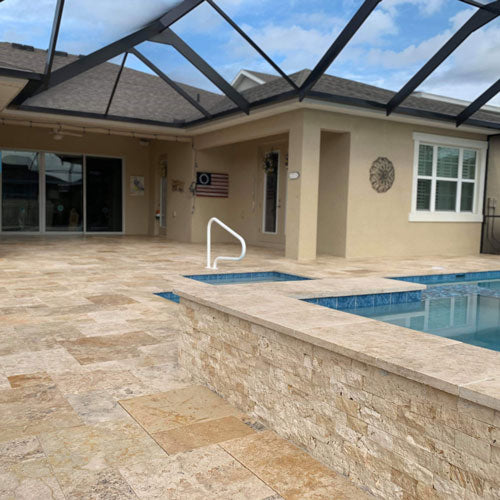 Screened-in back patio with a pool and stone floors